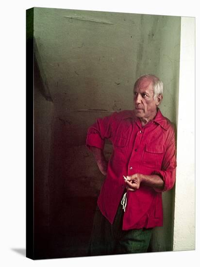 Pablo Picasso Leaning Against Wall and Holding Smoldering Cigarette-Gjon Mili-Premier Image Canvas