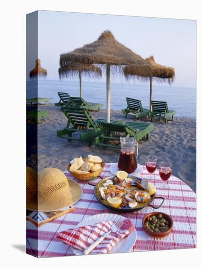 Paella with Olives, Bread and Sangria on a Table on the Beach in Andalucia, Spain-Michael Busselle-Premier Image Canvas