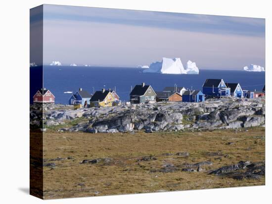 Painted Village Houses in Front of Icebergs in Disko Bay, West Coast, Greenland-Anthony Waltham-Premier Image Canvas