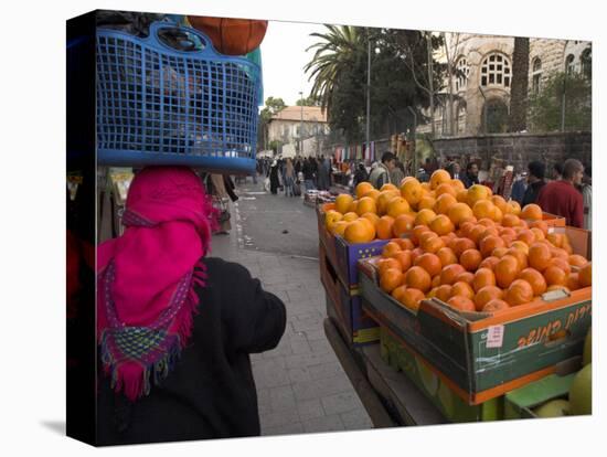 Palestinian Woman in Colourful Scarf and Carrying Bag on Her Head Walking Past an Orange Stall-Eitan Simanor-Premier Image Canvas