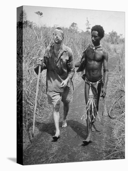 Papuan Native Helping a Wounded Australian Infantryman Along Road Away from the Buna Battlefront-George Silk-Premier Image Canvas