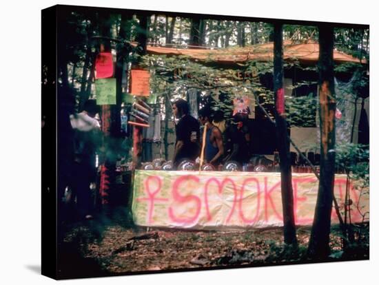 Paraphernalia Stand in Woods Featuring Pillows, Posters, and Incense, Woodstock Music and Art Fair-John Dominis-Premier Image Canvas