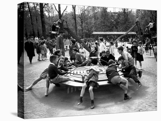 Parisian Children Riding Merry Go Round in a Playground-Alfred Eisenstaedt-Premier Image Canvas