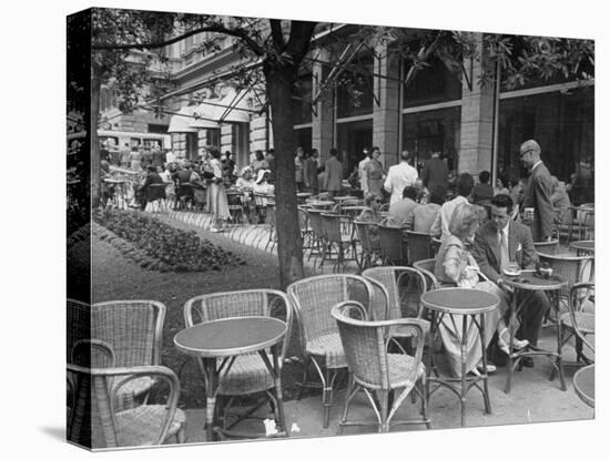 People Eating at a Sidewalk Cafe Next to the Excelsior Hotel-Dmitri Kessel-Premier Image Canvas