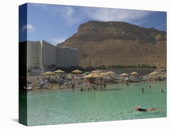 People Floating in the Sea and Hyatt Hotel and Desert Cliffs in Background, Dead Sea, Middle East-Eitan Simanor-Premier Image Canvas