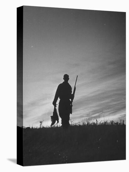 Pheasant Hunter Carrying Bird That He Killed-Wallace Kirkland-Premier Image Canvas