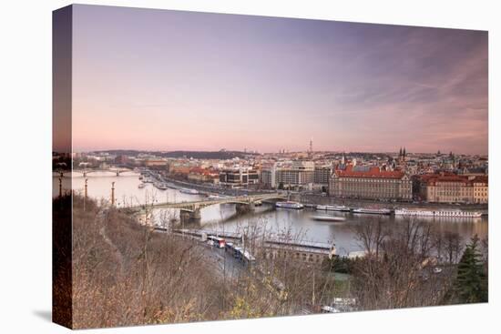 Pink sky on historical bridges and buildings reflected on Vltava River at sunset, Prague, Czech Rep-Roberto Moiola-Premier Image Canvas