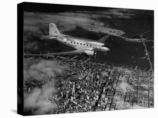 Plane Flying over a City from a Story Concerning United Airlines-Carl Mydans-Premier Image Canvas