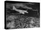 Plane Flying over a City from a Story Concerning United Airlines-Carl Mydans-Premier Image Canvas