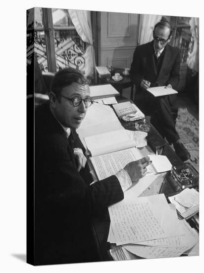 Playwright Jean Paul Sartre at His Desk as Artist Saul Steinberg Sketches at Sartre's Home in Paris-Gjon Mili-Premier Image Canvas