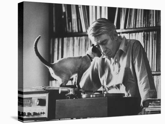 Poet Rod McKuen Playing Record on Stereo Set While Pet Siamese Cat Nuzzles His Face Affectionately-Ralph Crane-Premier Image Canvas