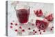 Pomegranate Pieces and a Glass of Pomegranate Juice on White Wooden Table-Jana Ihle-Premier Image Canvas
