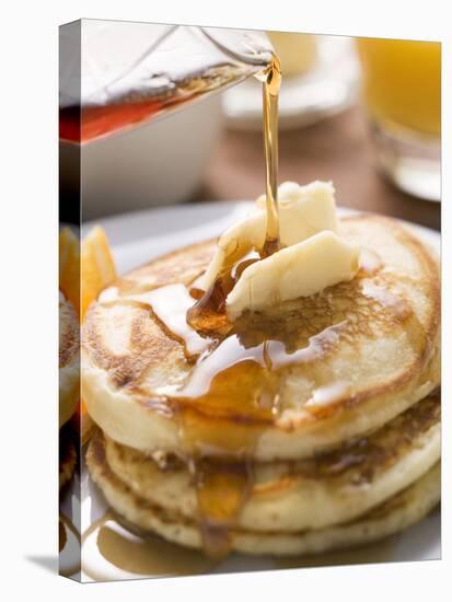 Pouring Maple Syrup over Pancakes with Dab of Butter-null-Premier Image Canvas