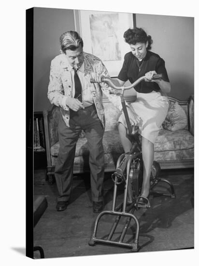 Producer-Director Preston Sturges and His Secretary Trying Out an Exercise Bicycle-John Florea-Premier Image Canvas