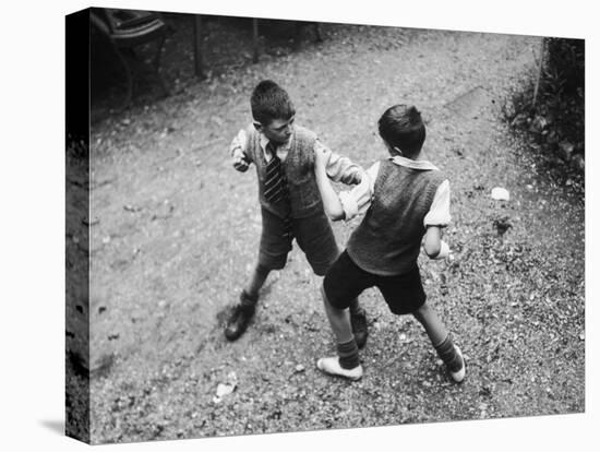 Put 'Em Up!' Two Boys Enjoy a Game of Fisticuffs in a Garden or Playground-null-Premier Image Canvas