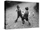 Put 'Em Up!' Two Boys Enjoy a Game of Fisticuffs in a Garden or Playground-null-Premier Image Canvas