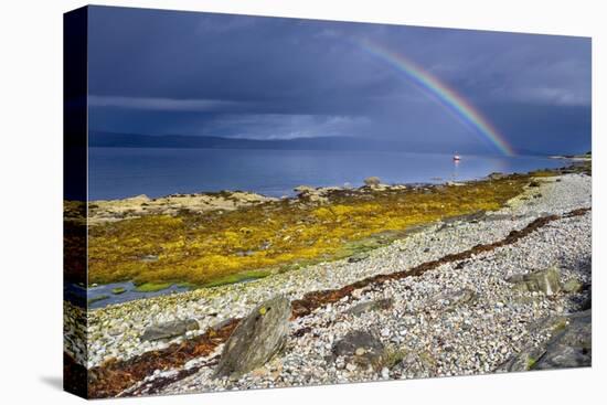 Rainbow Above Rocky Beach and Small Boat-null-Premier Image Canvas