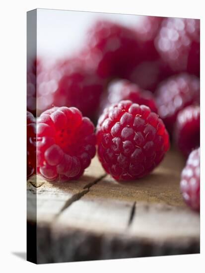 Raspberries on a Wooden Surface-Martina Schindler-Premier Image Canvas