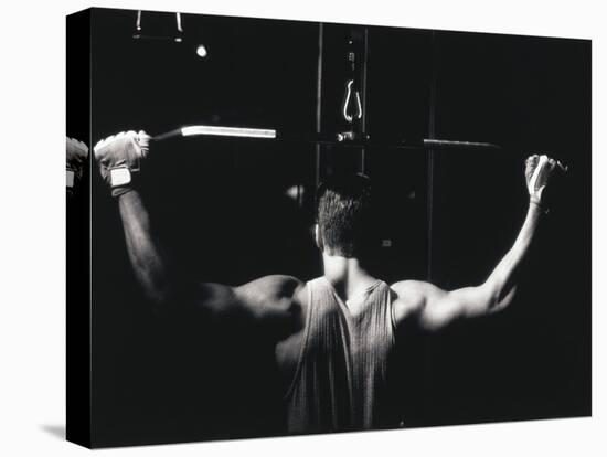 Rear View of a Young Man Exercise on a Lateral Pull-Down Weight Machine-null-Premier Image Canvas