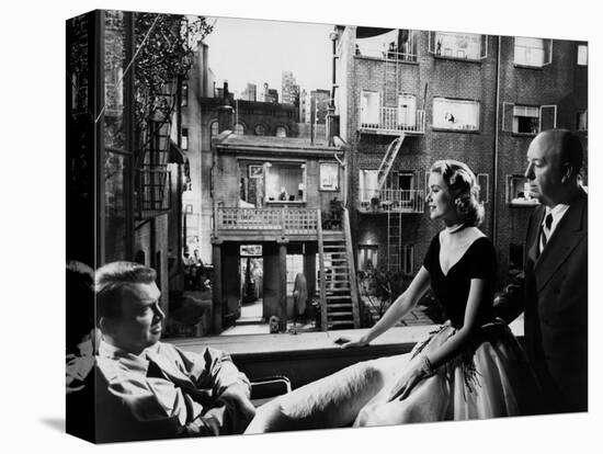 REAR WINDOW, 1954 directed byALFRED HITCHCOCK On the set, Grace Kelly between James Stewart and Alf-null-Stretched Canvas