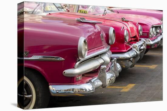 Red and pink vintage American car taxis on street in Havana, Cuba, West Indies, Central America-Ed Hasler-Premier Image Canvas
