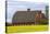 Red barn surrounded by canola in the Flathead Valley, Montana, USA-Chuck Haney-Premier Image Canvas