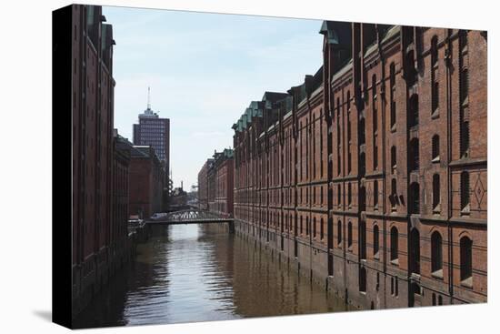 Red Brick Warehouses Overlook a Canal in the Speicherstadt District-Stuart Forster-Premier Image Canvas