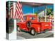 Red Dodge Pickup truck parked in front of vintage gas station in Santa Paula, California-null-Premier Image Canvas