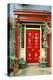 Red door with painted daisies, surrounded by flowers and vines.-Tom Haseltine-Premier Image Canvas