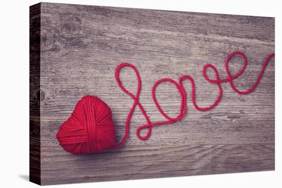 Red Heart of Red Wool Yarn on a Wooden Background-egal-Premier Image Canvas