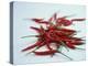 Red Hot Chillies on a White Sheet-Charcrit Boonsom-Premier Image Canvas