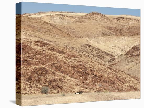 Red Rocky Landscape with Jeep in Distance, Purros Conservancy Wilderness, Kaokoland, Namibia-Kim Walker-Premier Image Canvas