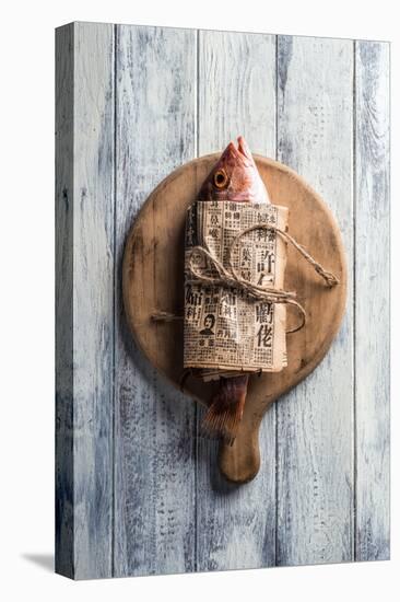 Red Snapper Wrapped in Chinese Newspaper on Wooden Background-Gary Jones-Premier Image Canvas