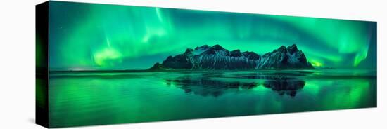 Reflection of Aurora Borealis in the sea with Vestrahorn mountains in center, Stokksnes Beach, S...-null-Stretched Canvas