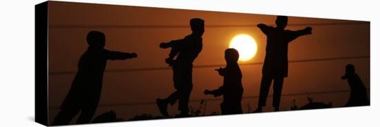 Refugee Children Playing on a Railway Near their Camp at Sunset, in Islamabad, Pakistan-null-Premier Image Canvas