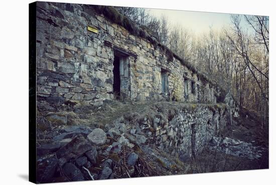 Remains of a bunker with door and windows at a mountain in a wood in winter in Alsace-Axel Killian-Stretched Canvas