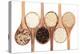 Rice Varieties In Olive Wood Spoons Over White Background-marilyna-Stretched Canvas