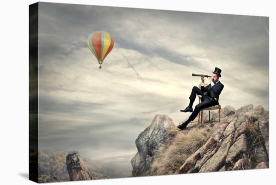 Rich Businessman Sitting On A Chair In The Mountain Looking The Landscape With Spyglass-olly2-Stretched Canvas