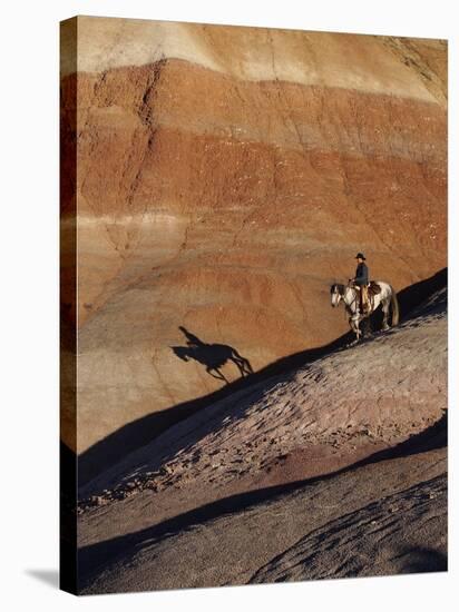 Rider with Shadow Coming down Hill in Painted Desert-Terry Eggers-Premier Image Canvas