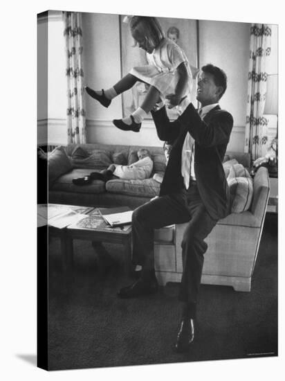 Robert F. Kennedy Playfully Tossing His Daughter Mary Kerry Kennedy Into the Air-John Dominis-Premier Image Canvas