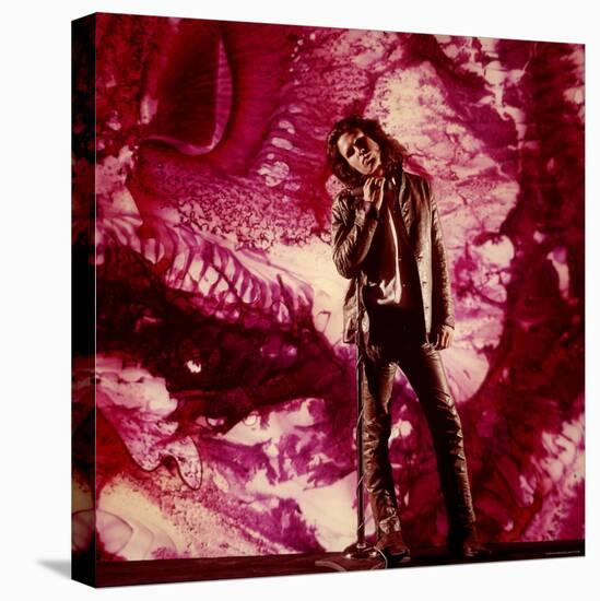 Rock Star Jim Morrison of the Doors Standing Alone in Front of a Purple Psychedelic Backdrop-Yale Joel-Premier Image Canvas