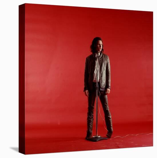 Rock Star Jim Morrison of the Doors Standing Behind Microphone Alone Against a Red Backdrop-Yale Joel-Premier Image Canvas