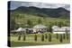 Romania, Maramures Region, Rona de Jos, Village View with Haystacks-Walter Bibikow-Premier Image Canvas