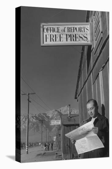 Roy Takeno Reading Paper in Front of Office-Ansel Adams-Stretched Canvas