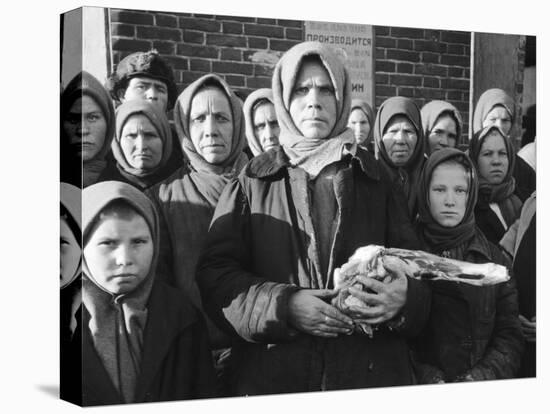 Russian Woman Grimly Holding a Slab of Meat as Other Peasant Women Staunchly Stand by in Siberia-Margaret Bourke-White-Premier Image Canvas