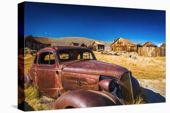 Rusted car and buildings, Bodie State Historic Park, California, USA-Russ Bishop-Premier Image Canvas
