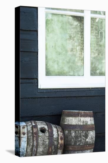 Rustic Barrels Lined Up Along an Old House Below a Window-Sheila Haddad-Premier Image Canvas