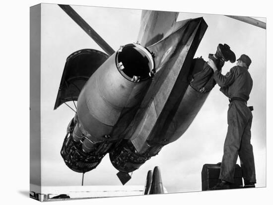 SAC's Maintenance Mechanic Sliding Into Barrel of Bomber's Jet Engine with the Help of His Partner-Margaret Bourke-White-Premier Image Canvas