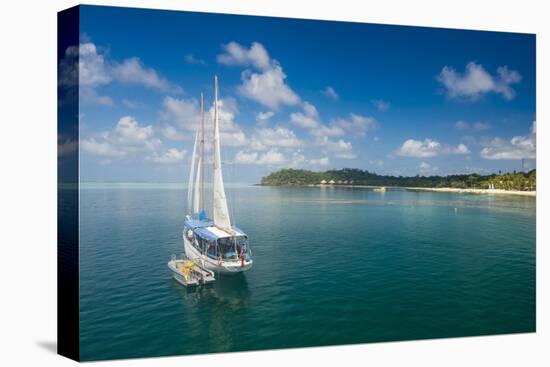 Sailing boat anchoring on Mana Island, Mamanuca Islands, Fiji, South Pacific-Michael Runkel-Premier Image Canvas