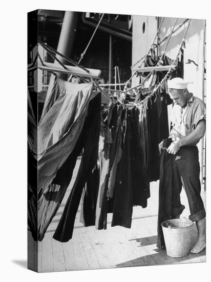 Sailor Aboard a Us Navy Cruiser at Sea Hanging Up Laundered Dungarees During WWII-Ralph Morse-Premier Image Canvas